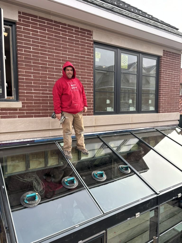 Chris from our crew setting glass on a custom sloped-glazing bank