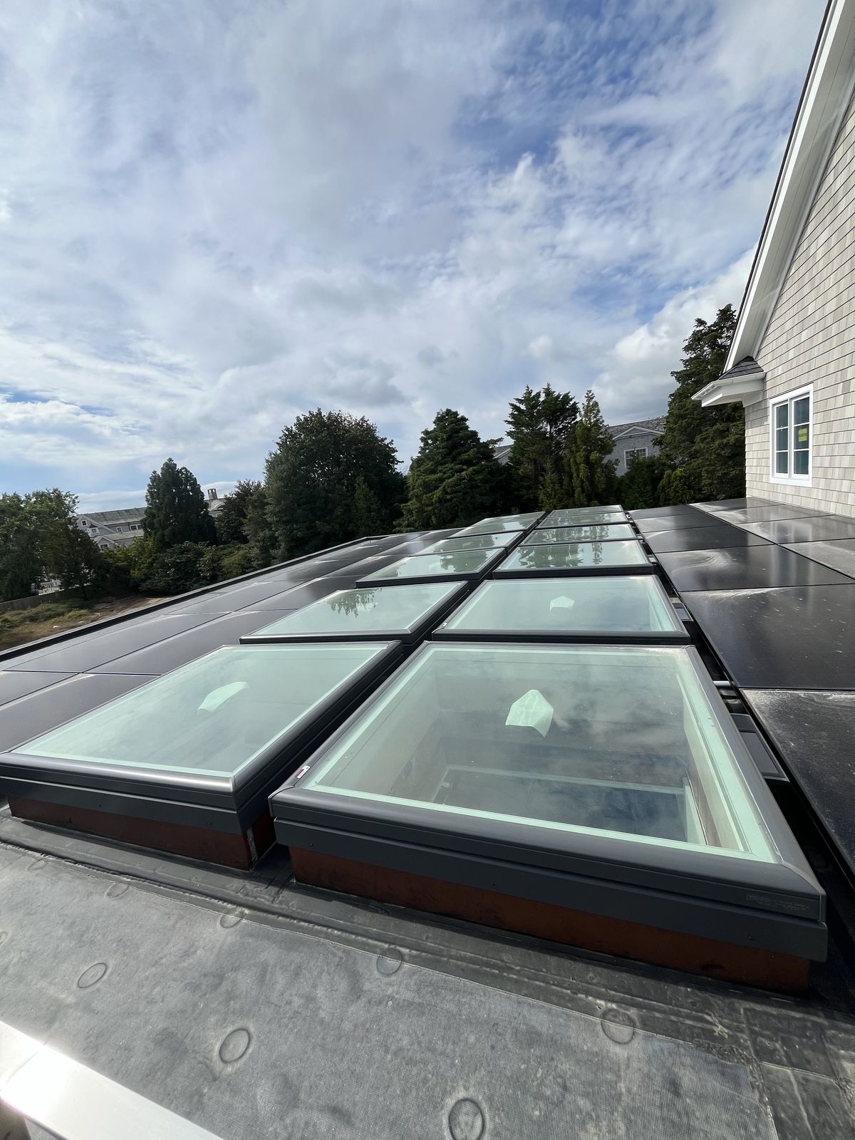 Bank of flat-glass skylights on a flat roof