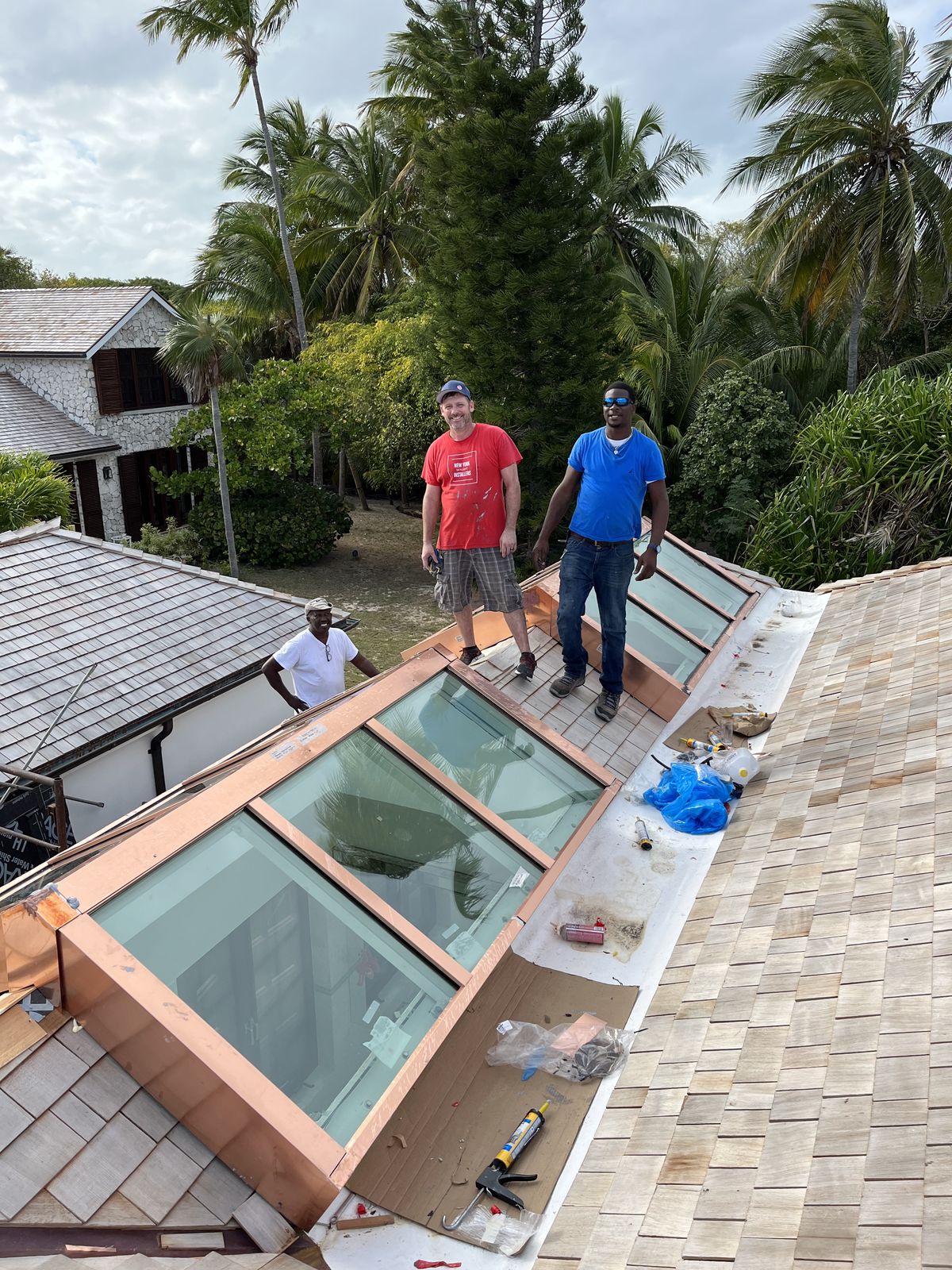 Owner John Campbell and crew — copper-clad ridge skylights, island estate