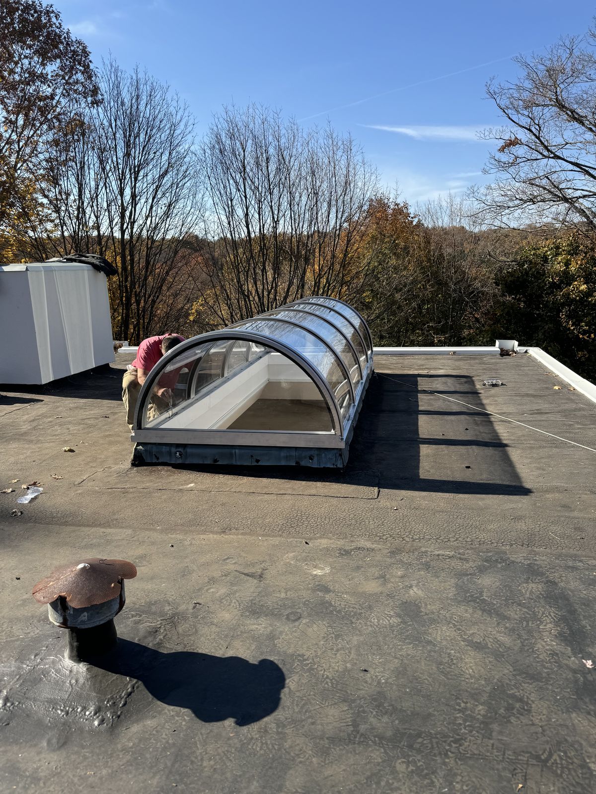 Curved glass replacement on a flat roof