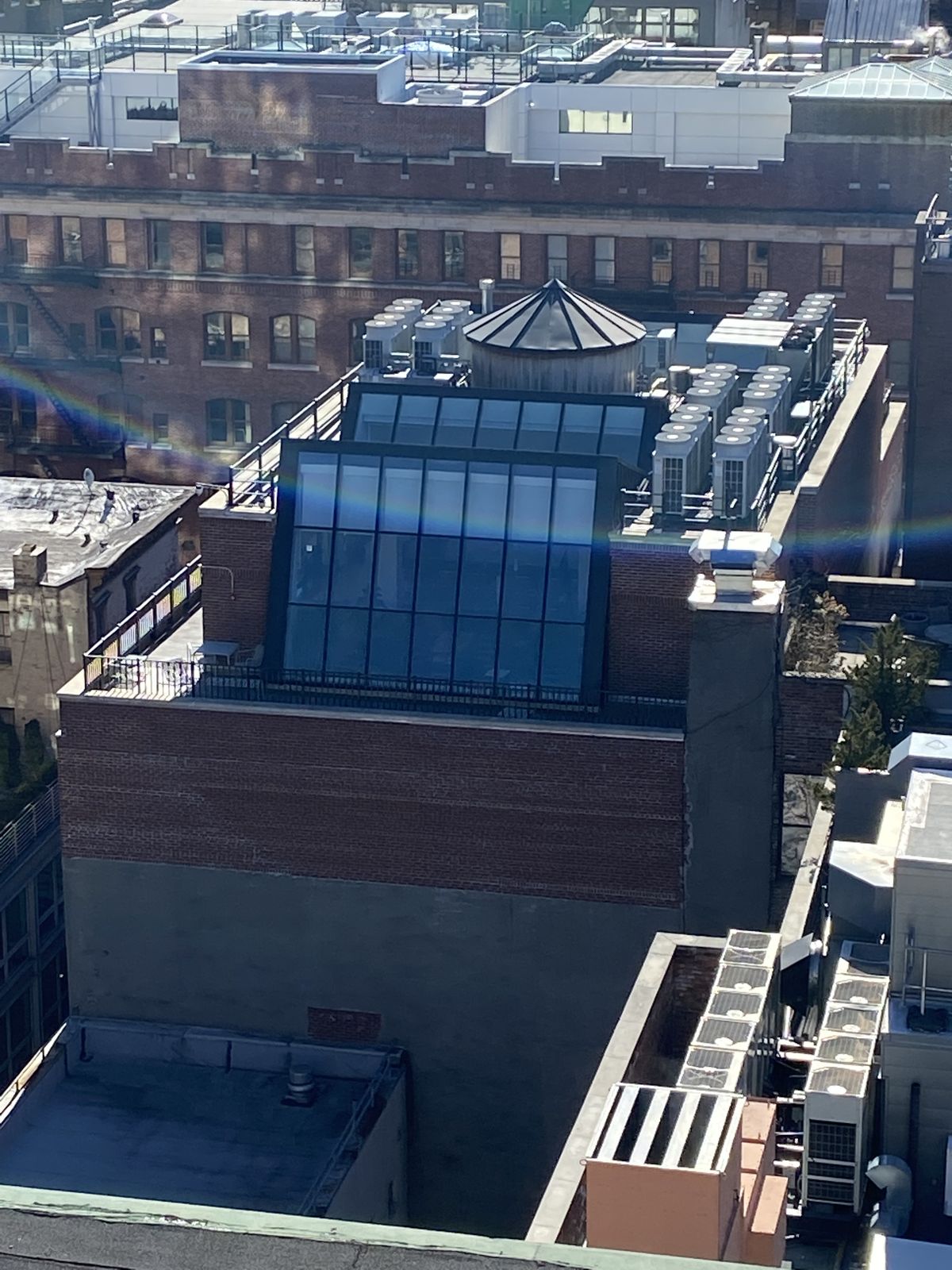 Penthouse glass from above — sloped glazing and conical skylight
