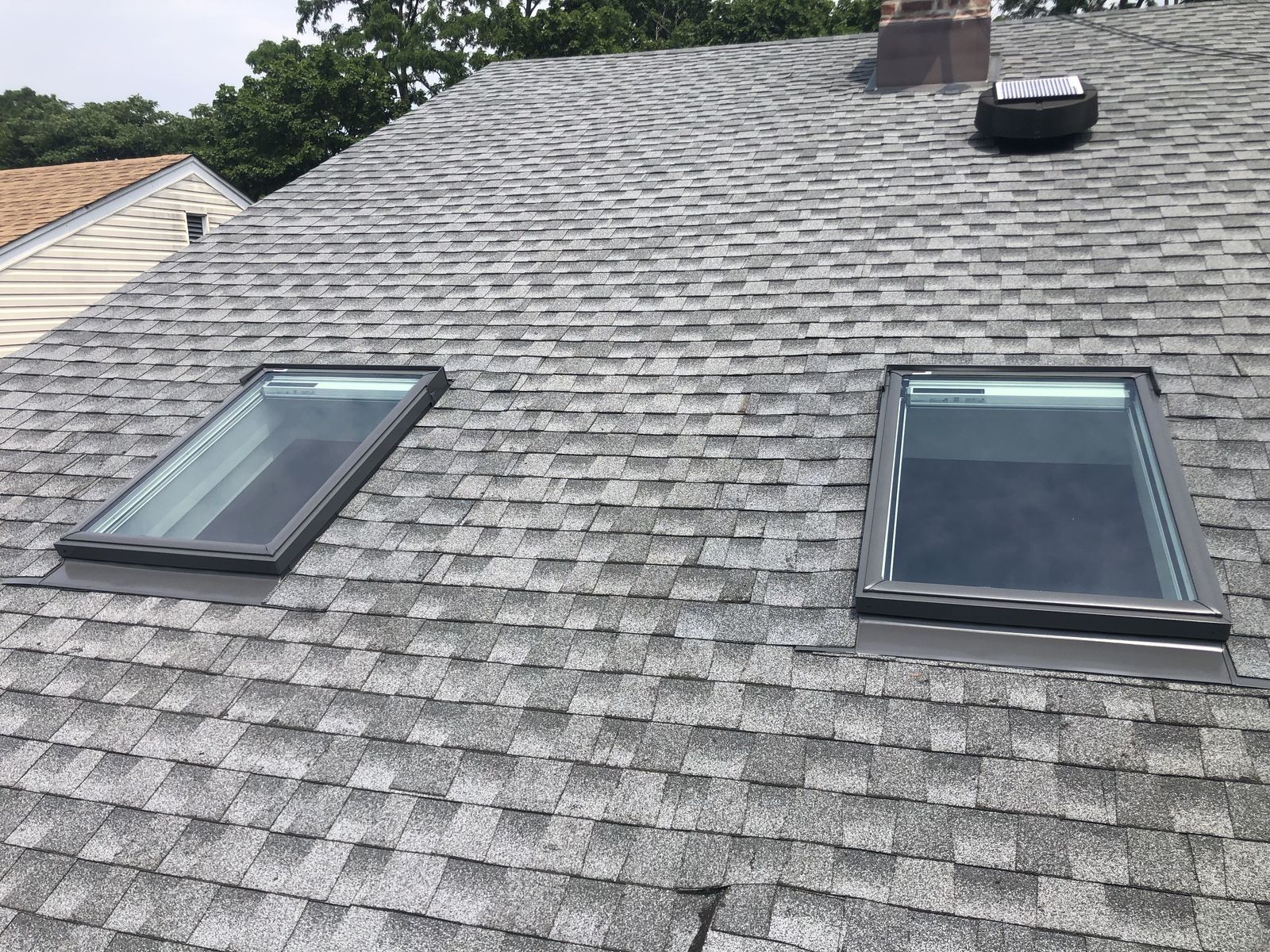 Twin deck-mounted skylights, shingle roof